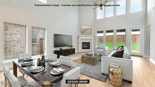 Living room with ceiling fan, a towering ceiling, and light wood-type flooring