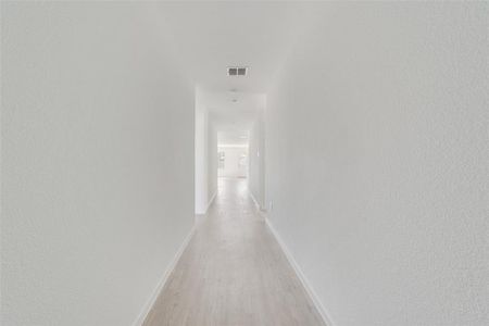 Hall with light hardwood / wood-style flooring