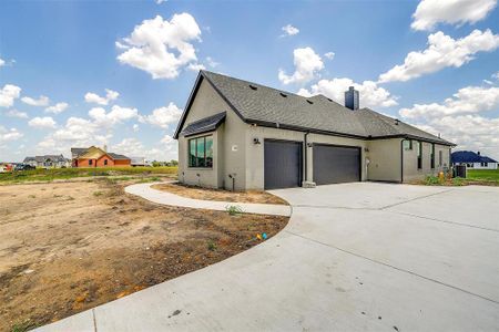 View of property exterior featuring a garage