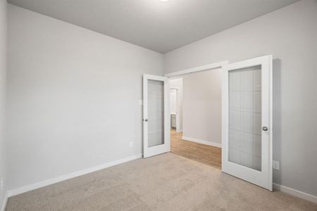 Another view of the office adorned with French doors. Sample photo of completed home with similar floor plan. As-built interior colors and selections may vary.