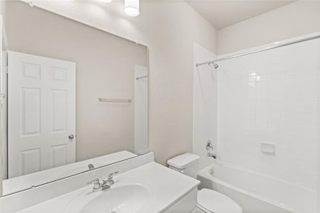 The secondary bath features tile flooring, white cabinetry and light countertops and a shower/tub combo. Perfect for accommodating any visiting family and friends.