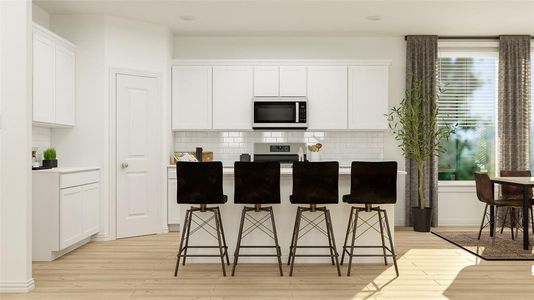 Kitchen with white cabinetry, appliances with stainless steel finishes, a center island, and light hardwood / wood-style flooring