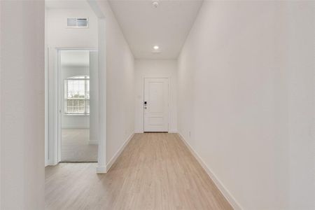 Hall featuring light wood-type flooring