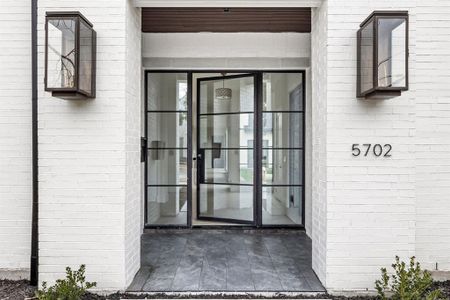 View of exterior entry featuring brick siding