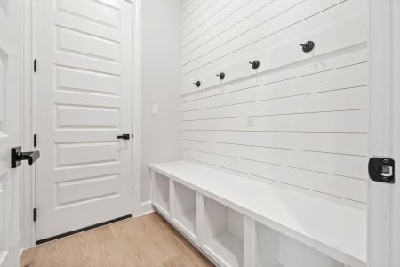 Mudroom and laundry room are conveniently adjacent as you enter from the garage.