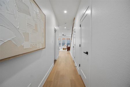 Hall with light hardwood / wood-style floors