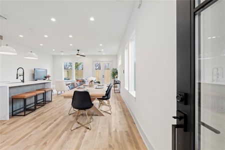 A welcoming entryway featuring a modern wood and glass front door, allowing natural light to stream into the home.