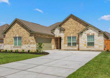 Lush front yard landscaping and a long driveway