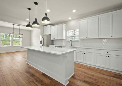 An oversized quartz island is located in the kitchen.