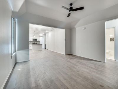 Unfurnished living room featuring light wood-type flooring and ceiling fan