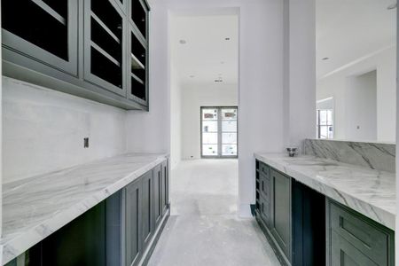 Wet bar between the dining room and living room/kitchen perfect for entertaining. Backsplash, ice maker and wine chiller to be installed.