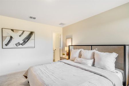 Bedroom featuring light carpet