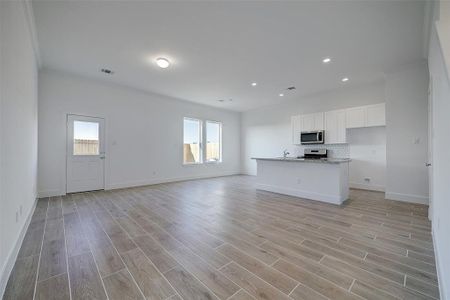 Guests are welcomed by wood-like tile flooring that extends throughout the living areas, enhancing the home's durability. 10ft ceilings are decorated with crown molding throughout the living areas.