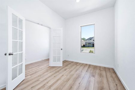 Your perfect workspace! This bright and inviting office offers privacy and productivity with its elegant French doors and a view of the front yard.