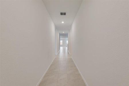 Corridor featuring light tile patterned flooring