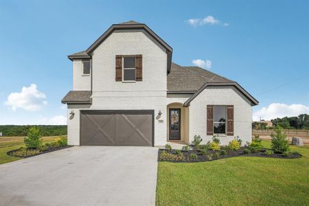 Front of property featuring a garage and a front lawn