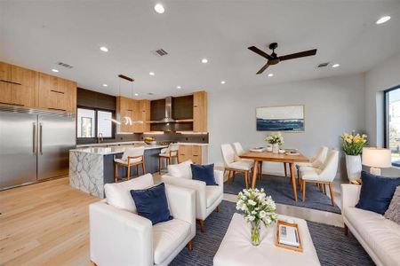 Living room featuring ceiling fan, plenty of natural light, light hardwood / wood-style floors, and sink