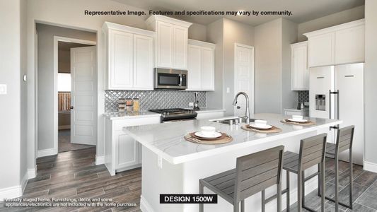 Kitchen featuring white cabinetry, stainless steel appliances, and an island with sink