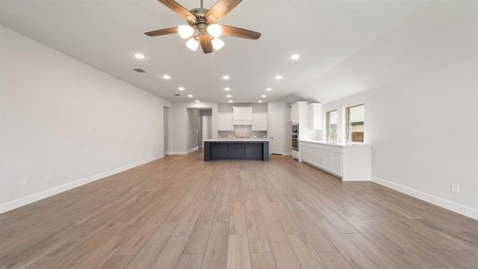 Unfurnished living room featuring light hardwood / wood-style flooring and ceiling fan