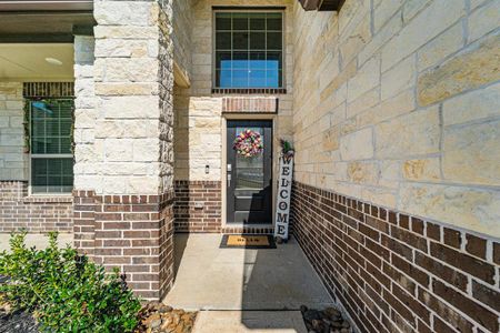 Charming front entrance featuring a stunning stone and brick facade.