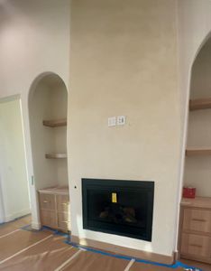 This is a must see in person feature. The fireplace is Venetian plaster and it is gorgeous. The look is mimicked on the vent hood, pulling it all together in harmony.