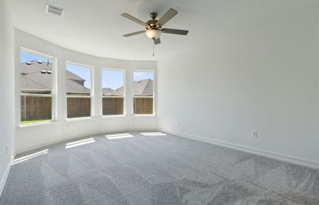 Elegant owner's suite with bay window *real home pictured