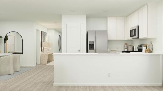 Kitchen with white cabinets, appliances with stainless steel finishes, light hardwood / wood-style flooring, and sink