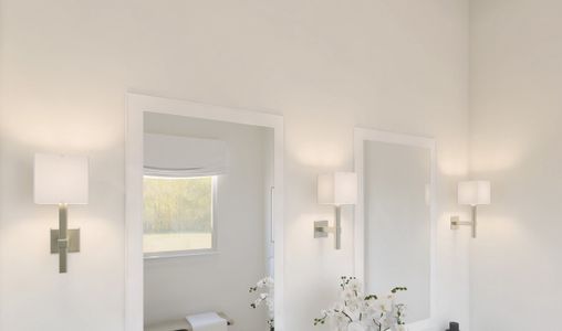 White-framed mirrors and lights with linen shades in the primary bath