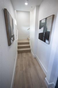 Corridor with hardwood / wood-style flooring