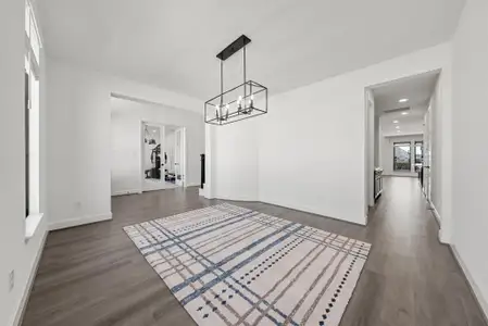 Unfurnished dining area with dark wood-style floors, baseboards, and recessed lighting