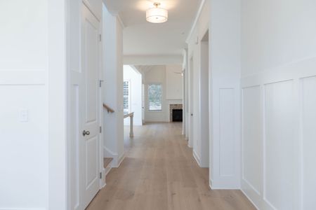 The foyer leads to the open kitchen, casual dining, and family room