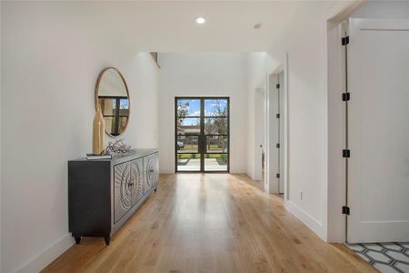 Hall with light hardwood / wood-style flooring