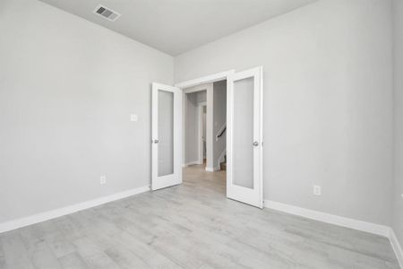 Another view of home office equipped with French doors. Sample photo of completed home. Actual colors and selections may vary.