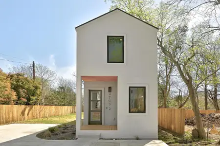 View of front of property with stucco siding and fence