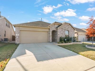 View of front of property with a garage, a front lawn, and central air condition unit