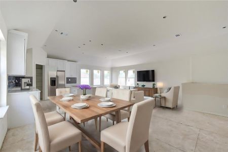 Gather around the dining table in this spacious area designed for both casual meals and formal gatherings. The modern kitchen, equipped with sleek cabinetry and a large pantry, ensures you have everything you need within reach. The flow from kitchen to dining makes it easy to serve and entertain. **This image is from another Saratoga Home - Artemis floorplan.**