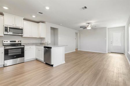 Spacious living room, open to the kitchen and dining area.