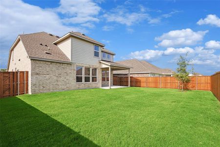 Rear view of property featuring a patio and a yard