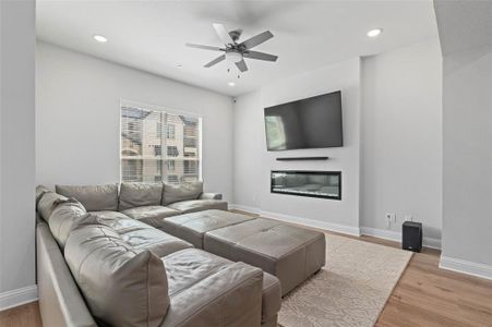 Living room featuring light hardwood / wood-style flooring and ceiling fan