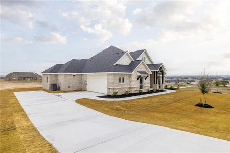 View of front facade featuring a front lawn, a garage, and cooling unit