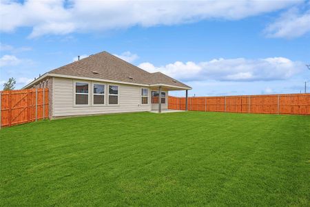 Back of property featuring a lawn and a patio area