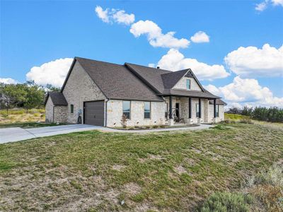 View of front of home featuring a garage and a front lawn