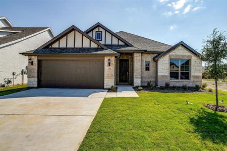 View of front of home featuring a garage and a front yard