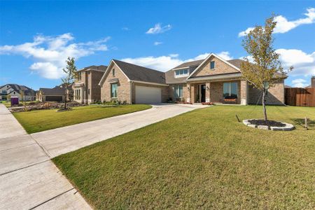 Craftsman inspired home featuring a front yard and a garage