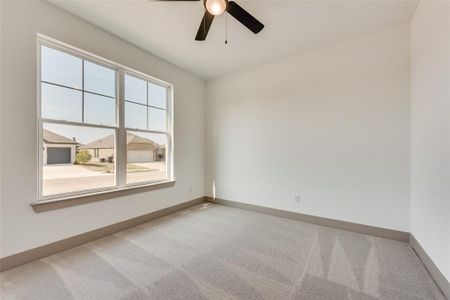 Empty room featuring ceiling fan and light colored carpet