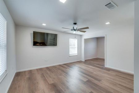 Spare room featuring hardwood / wood-style floors and ceiling fan