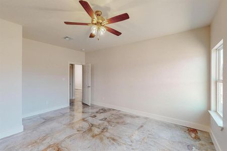 Spare room with ceiling fan