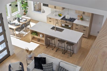 Living room featuring a high ceiling and light hardwood / wood-style flooring