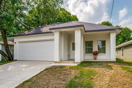 Ranch-style house featuring a garage and a front yard