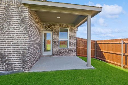 Entrance to property with a yard and a patio area